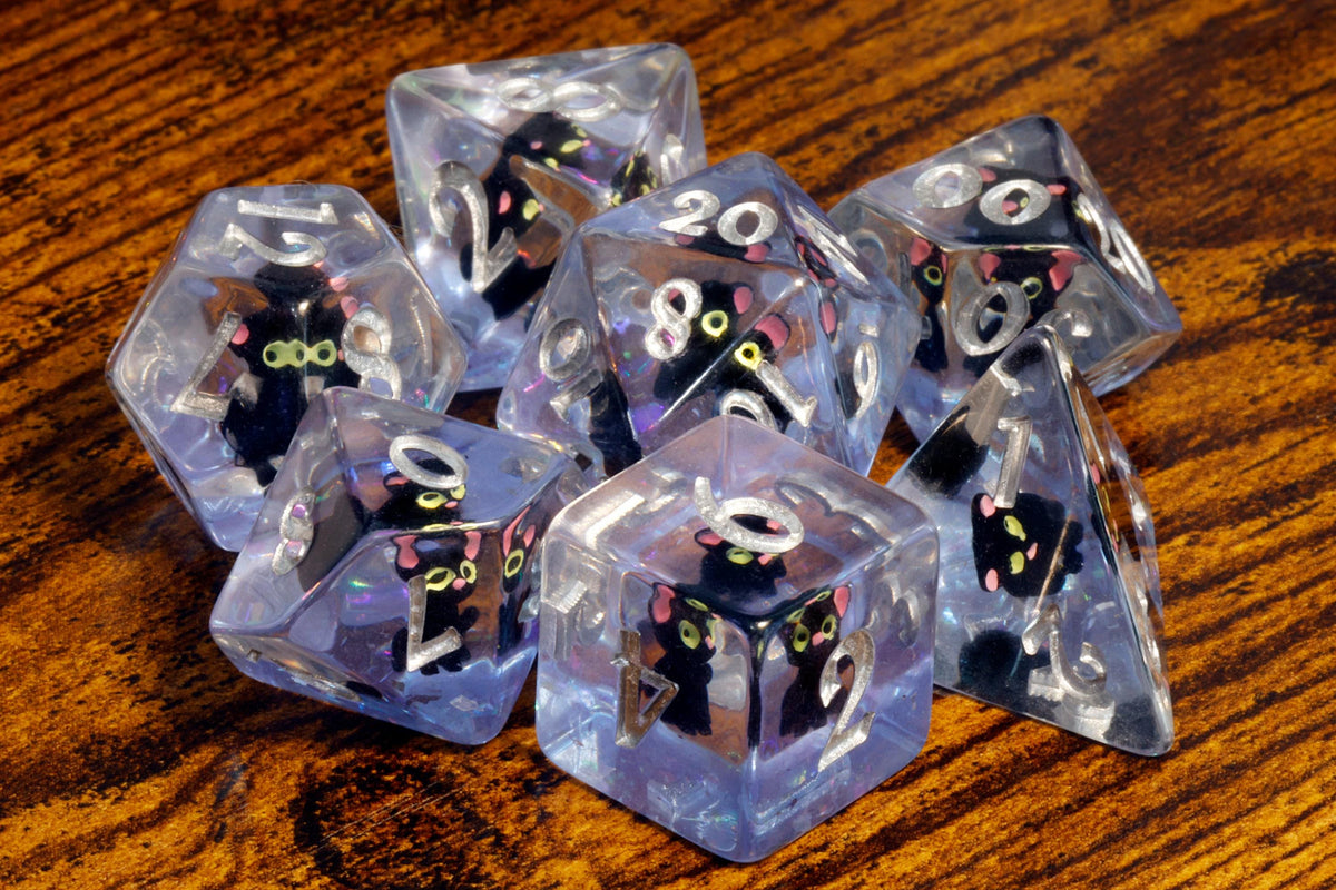 Black cat polyhedral dice with tiny black cat inclusions on a purple glitter layer - The Wizard's Vault
