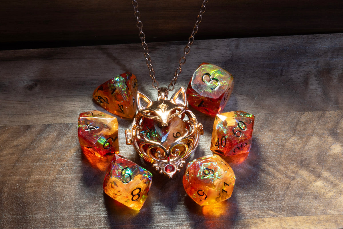 Fox pendant in a copper finish with the Amber Opal dice set on wood