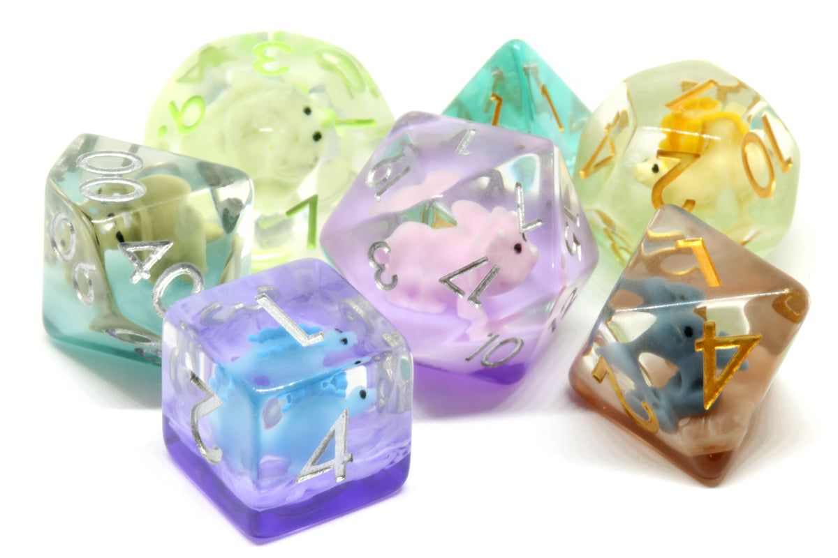 Mixed dinosaur resin dice with miniature dinosaur inclusions