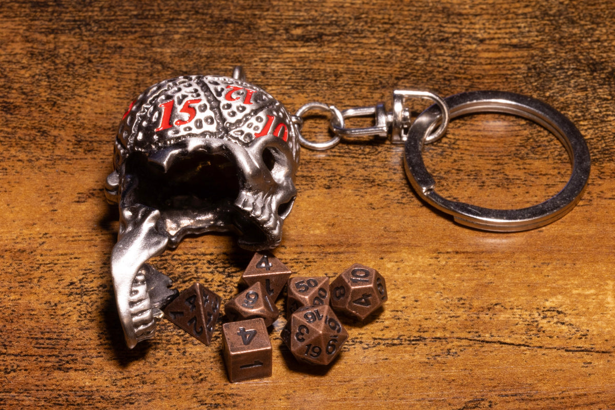 Skull Dice Keeper Keychain – Metal Skull with Miniature 7-Piece Copper Dice Set