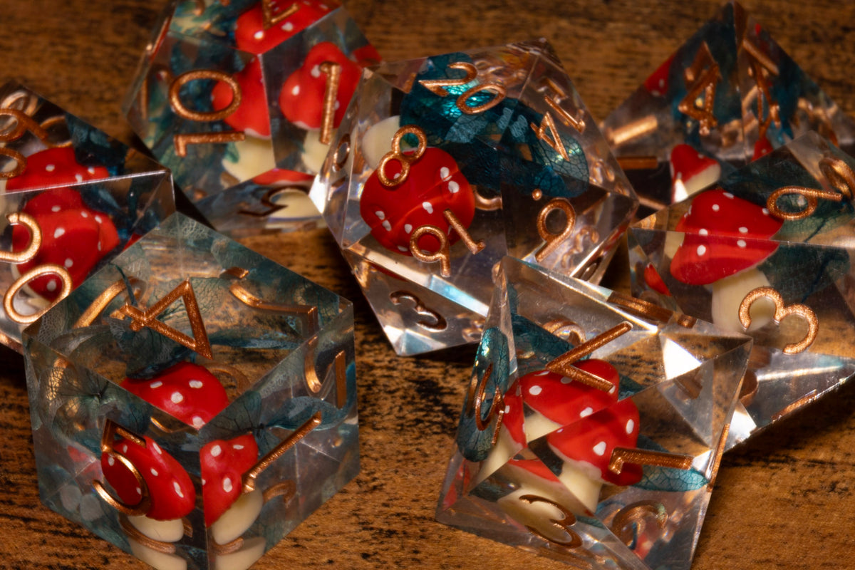Toadstool Hollow 7-Piece Sharp Edge Dice Set – Clear with Red Mushroom & Moss Inclusions