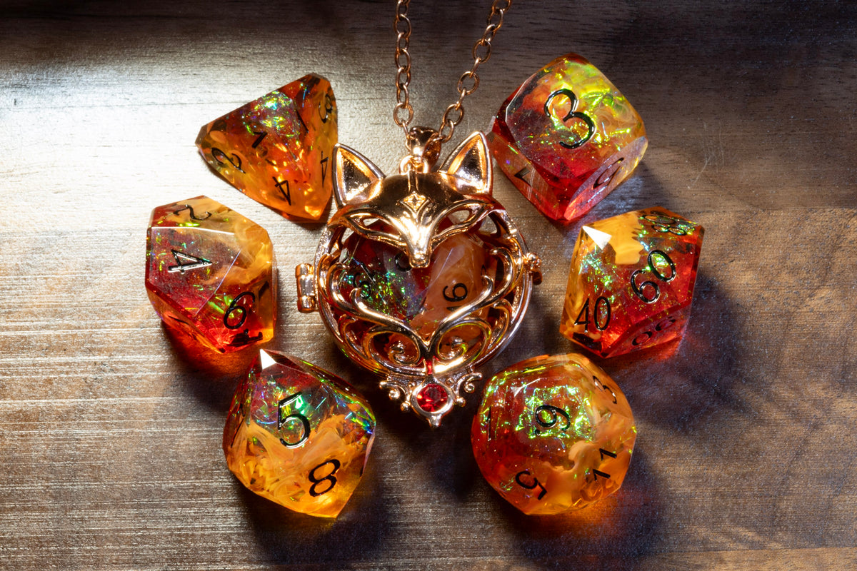 Fox pendant in a copper finish with the Amber Opal dice set on wood