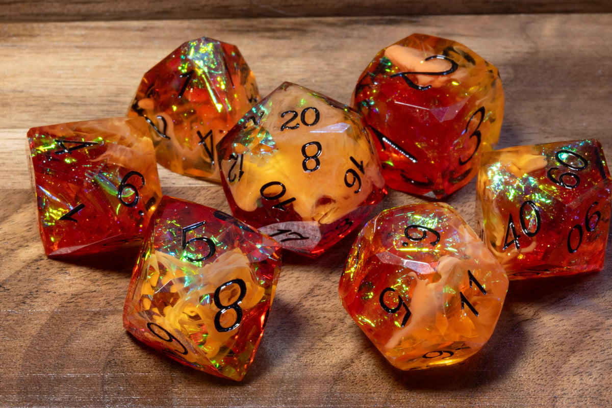 Amber Opal sharp-edge dice set in amber and orange-red resin with holographic foil on wood
