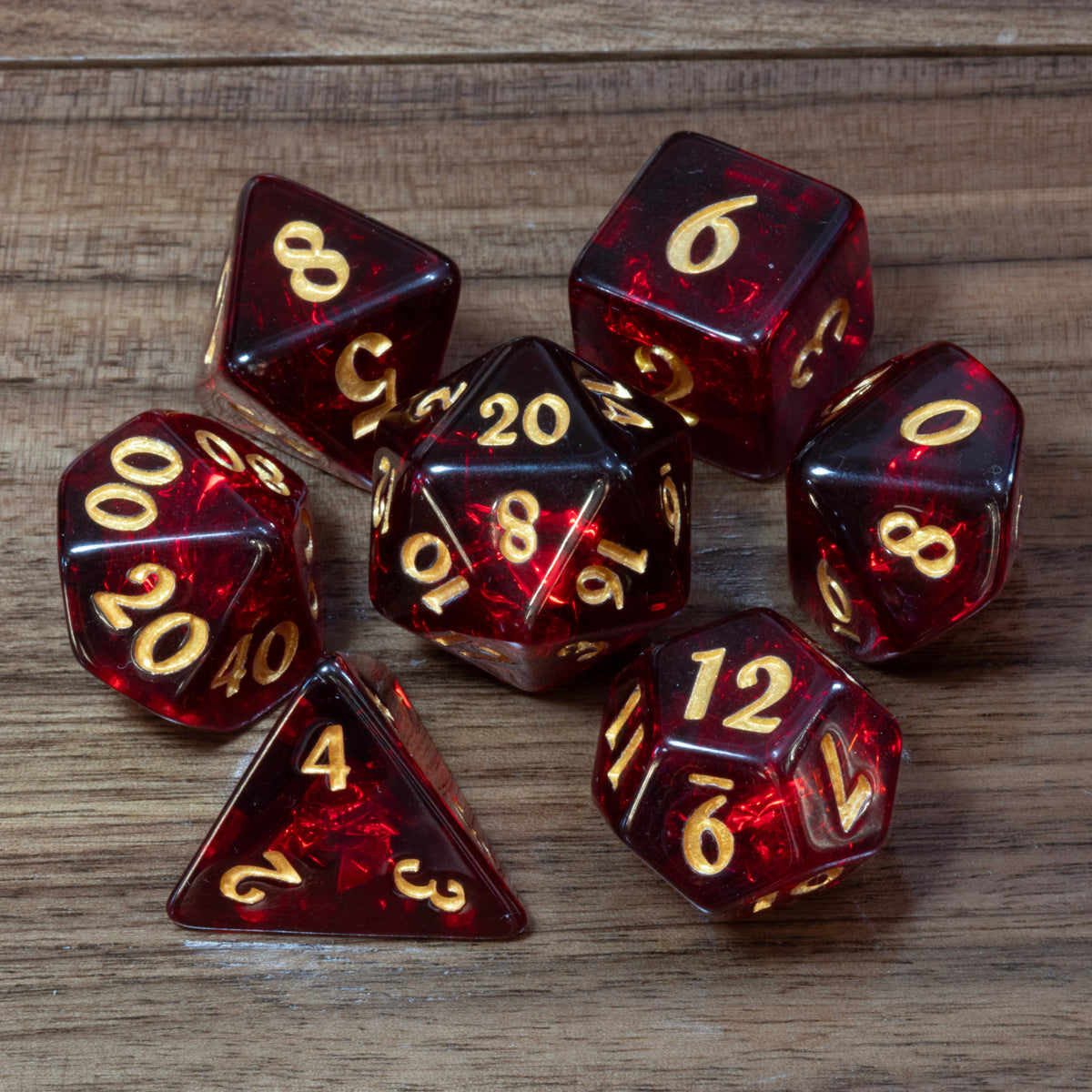 Cherry Opal dice set, transparent dark red resin with holographic inclusions and gold numbers