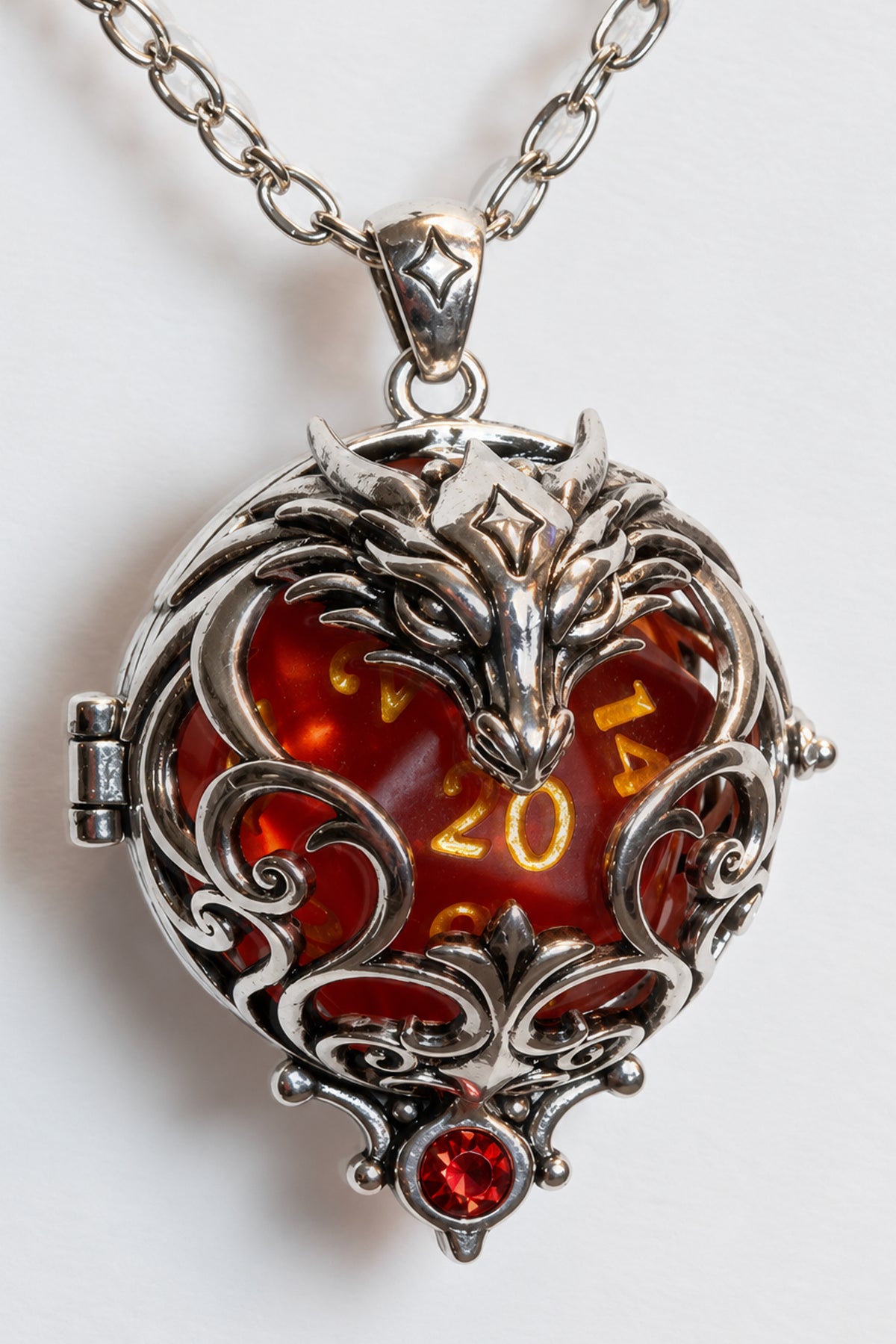 Dragon pendant in a silver finish, open-work scrolls around a red D20 showing 20, red crystal at the base, on a silver-finish chain